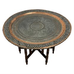 20th century Benares table, circular pierced copper tray top decorated with concentric floral pattern, on folding wooden base