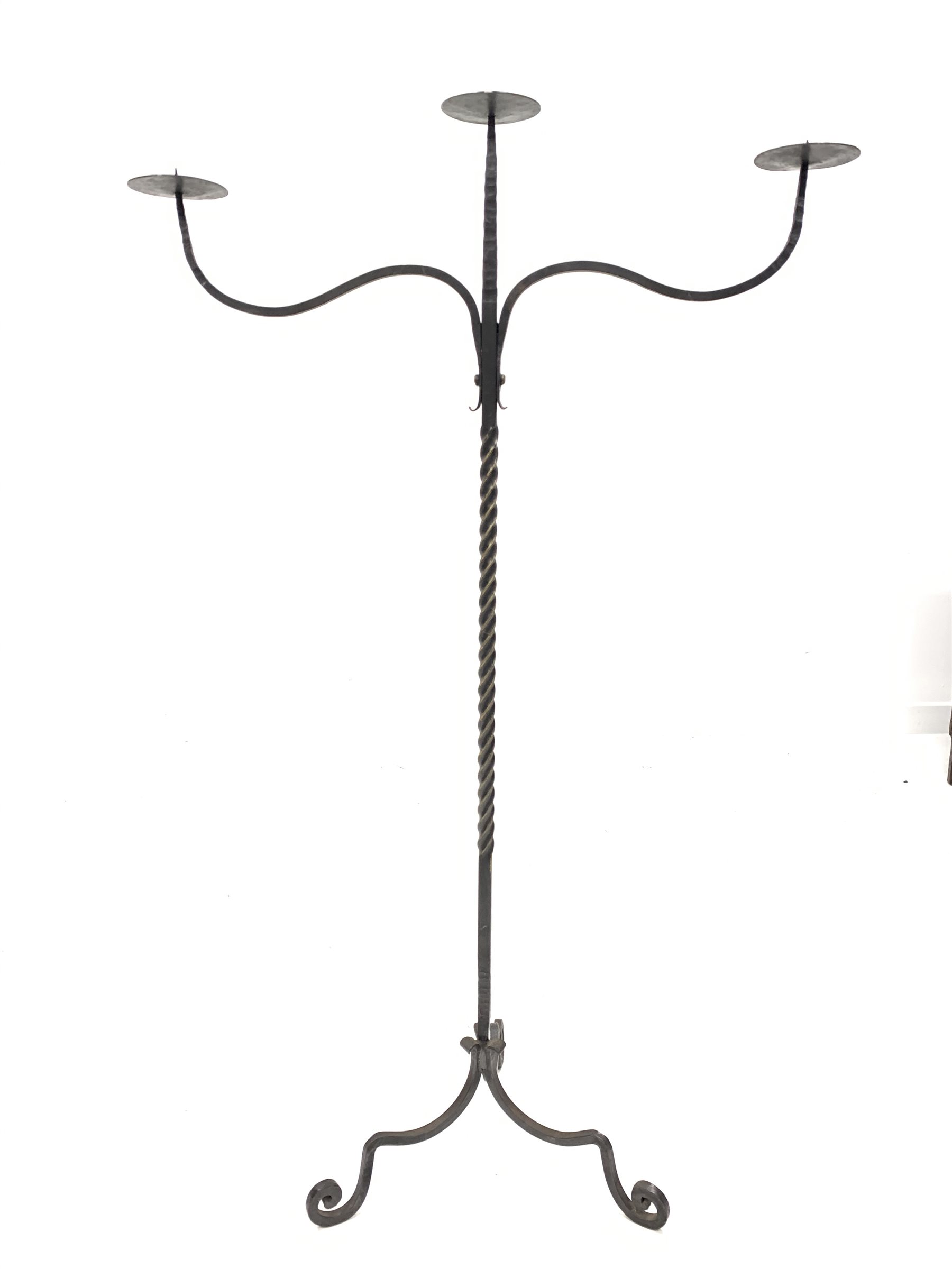 Wrought iron three branch floor standing candelabra, with twisted ...