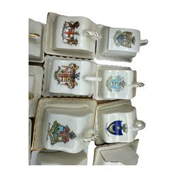 Collection of crested ware miniature cheese dishes and covers, including one by Goss, in one box