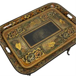 19th century tole ware tray of rectangular form, decorated with Japanese inspired floral motifs and gilt shells, with pierced handles, the associated ebonised and gilt stand, raised on ring turned splayed supports united by X-stretcher, decorated with gilt foliage