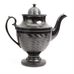 Six early 19th century and later black basalt tea and coffee pots, mostly with relief or engine-turned bodies, including a Cyples 'Egyptian black’ engine turned coffee pot on pedestal foot, another with shamrock, thistle and rose moulded decoration and four others 