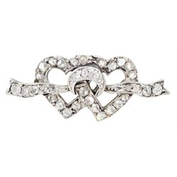 Late 19th century silver and gold, old cut diamond double heart brooch, two entwined hearts tied by a ribbon and set throughout with old cut and rose cut diamonds, total diamond weight 0.25 carat