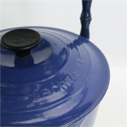 Set of three Le Creuset blue enamel saucepans, on a pierced blue painted cast iron stand, H68cm Le Creuset oval oven dish, casserole pot and other ovenwares 