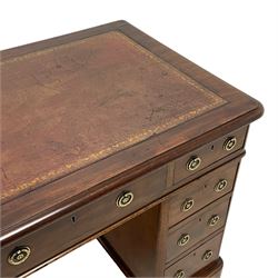 Victorian mahogany twin pedestal desk, moulded rectangular top with rounded corners and inset leather writing surface, fitted with nine drawers, on moulded plinth base