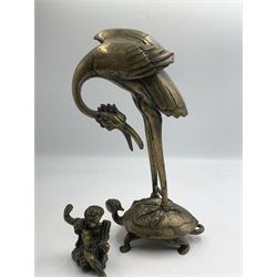 Early 20th century Japanese bronze figure or Okimono, modelled as a crane standing atop a turtle shell, possibly a candle holder, H25cm together with a small bronze figure modelled as a seated Cherub, H7cm (2)