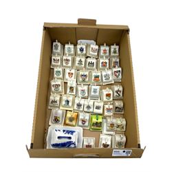 Collection of crested ware miniature cheese dishes and covers, including one by Goss, in one box