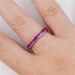 Platinum channel set calibre cut ruby and round cut diamond full eternity ring, the band with engraved decoration, stamped PLAT, total diamond weight approx 0.15 carat