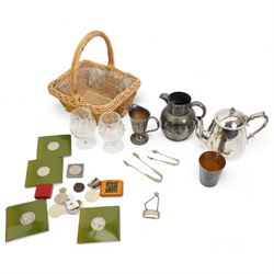 Commemorative and other coins, Mauchline ware box decorated with 'The Birds Nest' and two Stuart brandy glasses, in a small wicker basket 