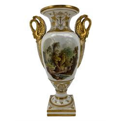 Early 19th century Derby vase, of campana urn form, decorated to one side with a hand painted reserve of a basket of flowers, within a scroll gilt border and twin serpent form handles, H20.5cm together with a Bloor Derby vase, hand painted with figures in a wooded landscape, with twin gilt swan form handles, upon a square pedestal foot, H25cm (2)