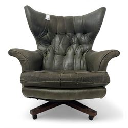 G-Plan - mid-20th century 'Blofeld' model 62 swivel wingback armchair, upholstered in green faux leather, on castors