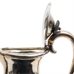 Silver oval teapot with ebonised lift, ivory insulators, loop handle and raised on four shaped supports and matching hot water jug Sheffield 1922/3 Maker Fenton Bros. Ltd. This item has been registered for sale under Section 10 of the APHA Ivory Act