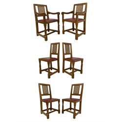 Mouseman - set of six (4+2) oak dining chairs, carved and pierced lattice back, oxblood leather upholstered seat with stud band, on octagonal front supports united by plain stretchers, each carved with mouse signature, by the workshop of Robert Thompson, Kilburn