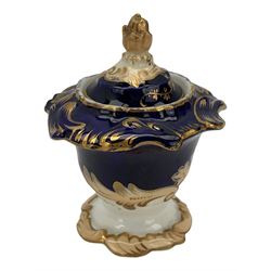 19th century porcelain inkstand, the oblong twin handled base centrally painted with a floral bouquet, flanked by two footed inkwells and covers, with rococo-inspired acanthus moulded borders and handles, pattern no. 2/3339, L26.5cm 