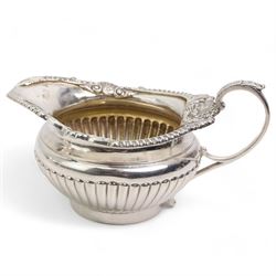 Late Victorian silver two handled sugar bowl with shell moulded and gadrooned border and leaf capped handles, crest of a lion passant and half body fluted decoration and matching milk jug London 1895 Maker Messrs Barnard (2)