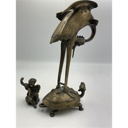 Early 20th century Japanese bronze figure or Okimono, modelled as a crane standing atop a turtle shell, possibly a candle holder, H25cm together with a small bronze figure modelled as a seated Cherub, H7cm (2)