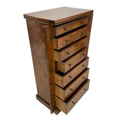 Victorian burr walnut Wellington chest, rectangular top with book-matched veneers, two hinged uprights with scrolled foliage carved brackets enclosing seven graduating drawers, on plinth base 