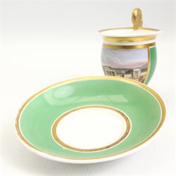 19th century French Empire design porcelain cup and saucer, the cup hand painetd with a panel, titled beneath 'Library, St Leonards, Near Hastings', against a green and gilt ground, cup H10.5cm 