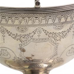 George III silver navette shape sugar basket with reeded loop handle, engraved cartouche and decoration and oval pedestal foot L15cm London 1788 Maker Henry Chawner