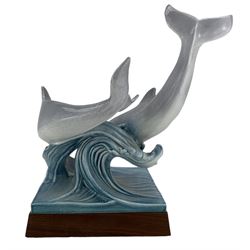 Tony Morris for Poole Pottery, leaping dolphin group, modelled over waves and mounted on a wooden base, H29cm. This model is a duplicate of a sculpture presented to Queen Elizabeth II and the Duke of Edinburgh on their visit to Poole Pottery in 1979, the original cast was destroyed after the production of the duplicate. Provenance: Arnold Smith, Chairman of Pool Potteries Collection