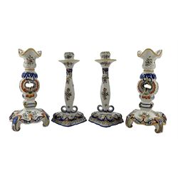 Pair of 19th century Fourmaintraux Freres Desvres faience candlesticks, each decorated with foliate scrolls, flowers, together with a similar later pair of candlesticks, H25.5cm (4)