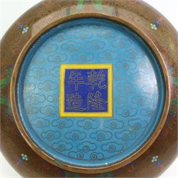 Chinese cloisonne bowl with inverted rim, decorated with geometric and floral design against a burnt orange ground, D21cm, a similar blue ground bowl, pepper pot and open salt, Japanese Inaba style cloisonne plate, decorated with an exotic bird amongst prunus, against a black ground, D15cm and another cloisonne dish (6)