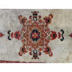 Moroccan amber ground thick pile rug, the plain ivory field decorated with a central pole medallion of star form, the wide guard bands decorated with repeating geometric and foliate patterns