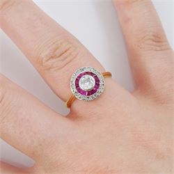 18ct gold calibre cut ruby and diamond target cluster ring, the central diamond with ruby and rose cut diamond surround, Sheffield 1982, principal diamond approx 0.25 carat