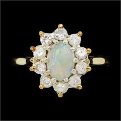 9ct gold oval opal and round brilliant cut diamond cluster ring, London 1982, total diamond weight approx 0.30 carat