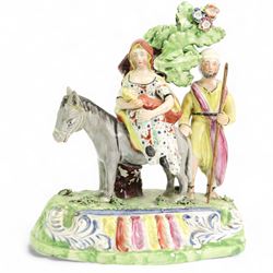 Early 19th century Obadiah Sherratt Pearlware group 'Flight to Egypt', c1820, modelled as the Holy Family with a donkey before bocage, on a scroll moulded base, H21.5cm x W19cm 