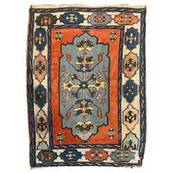 Turkish indigo ground rug, the shaped central field decorated with a central geometric stylised plant motif, enclosed with a guarded border decorated with contrasting motifs 