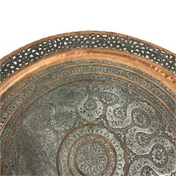 20th century Benares table, circular pierced copper tray top decorated with concentric floral pattern, on folding wooden base