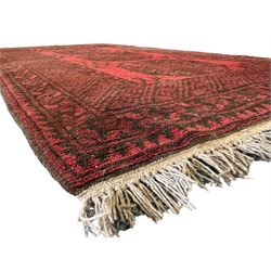 Afghan Baluch indigo ground rug, decorated with two central geometric lozenges, surrounded by a densely filled field and geometric guard bands (146cm x 88cm); Afghan red ground rug, the field decorated with columns of geometric motifs and stylised camels, enclosed by repeating crimson border (185cm x 91cm)