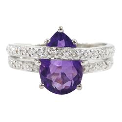 18ct gold amethyst and diamond ring, pear cut amethyst to a diamond set crossover band, stamped 750