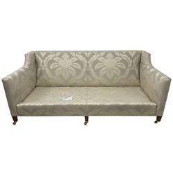 Duresta - Grande hardwood-framed three-seat sofa, upholstered in pale fabric decorated with repeating foliate pattern, on square tapering supports with brass castors 