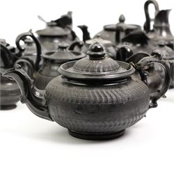 Early 19th century and later black basalt tea wares and similar stoneware, mostly with relief or engine turned bodies, including bachelors teapots, milk jugs, sucriers etc, in one box