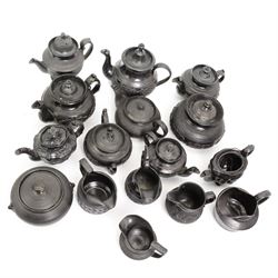 Early 19th century and later black basalt tea wares, mostly with relief or engine-turned bodies, including Cyples teapot, bachelors teapots, sucriers, jugs etc in one box