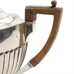 Victorian silver teapot of oval design with half body decoration, stained wood handle and lift London 1889 Maker Walter & John Barnard 