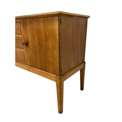 Gordon Russell - walnut sideboard, rectangular moulded top over three central drawers and flanking cupboards, fitted with turned handles, on tapering supports 