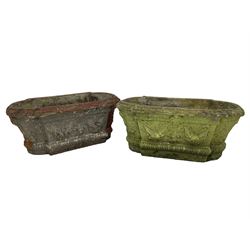 Pair of cast stone garden planters, rectangular form with stepped rounded ends, foliate moulded rim, the body decorated with floral and fruit festoons over gadrooned moulding