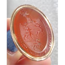 Large 19th century gold oval carnelian intaglio fob seal depicting three stags within a shield and mounted by a stag's head, engraved with the moto 'Virescit Vulnere Virtus'