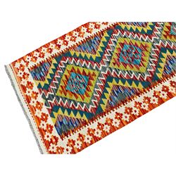 Chobi Kilim multi-colour runner rug, the field with five lozenges with concentric bands in contrasting colours, the ivory and amber border with further geometric shapes