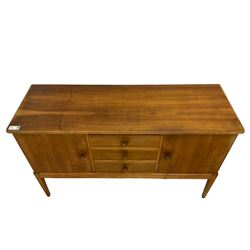 Gordon Russell - walnut sideboard, rectangular moulded top over three central drawers and flanking cupboards, fitted with turned handles, on tapering supports 