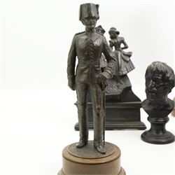 Spelter figure of a huntsman, bronzed figure of a Hussar, iron doorstop and two metal busts