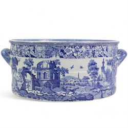 Early 19th century Staffordshire blue and white transfer printed footbath, of oval banded section, the exterior printed with a farmer herding cows down a country lane, the interior with figures and horses before a ruin, within floral borders, L52cm, H21cm, W36cm