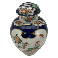 18th century Worcester tea caddy, of oval form and painted in the Kakiemon palette with reserves of flowers against a blue scale ground, H14cm together with a similar Worcester circular dish, painted with floral sprays, within a scalloped edge, blue crescent mark beneath, D19cm (2)