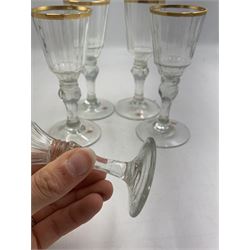 Set of four 19th century Baccarat liqueur/sherry glasses, circa 1820, with panelled bucket bowls and gilt rims, engraved CEG, to faceted knopped stems, together with another smaller example, H14cm and H12cm (5)