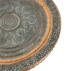 20th century Benares table, circular pierced copper tray top decorated with concentric floral pattern, on folding wooden base