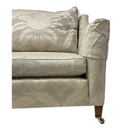 Duresta - Grande hardwood-framed three-seat sofa, upholstered in pale fabric decorated with repeating foliate pattern, on square tapering supports with brass castors 