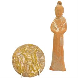 Islamic yellow glazed earthenware roundel, D10cm together with a Tang Dynasty terracotta style dignitary (2)