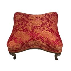 Late 20th century French design stained beech framed armchair and matching stool - the armchair with shaped and moulded frame carved with flower heads and foliage, upholstered in silk red and gold ground fabric with floral pattern, on scroll carved cabriole feet decorated with flower head carvings (W73cm, H82cm, D75cm); the footstool of concaved rectangular form with moulded frame carved with flower heads, upholstered loose cushion, on cabriole feet (70cm x 64cm, H48cm)